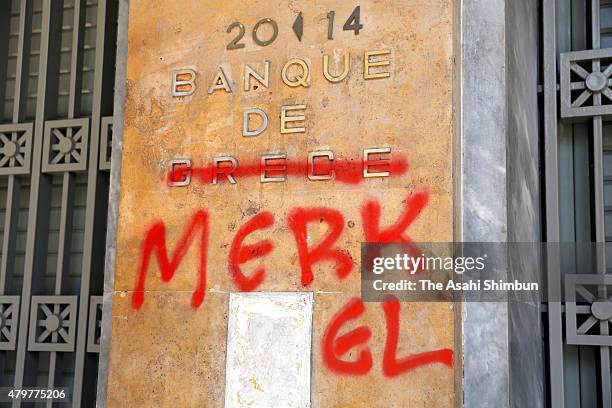 Sign outside the Bank of Greece is defaced with graffiti to read 'Banque de Merkel' on July 6, 2015 in Athens, Greece. Politicians in Europe and...