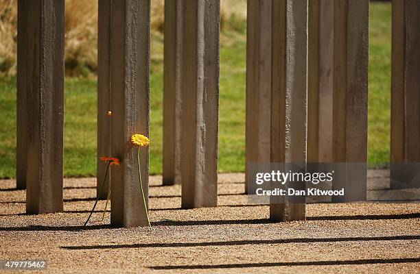 Flowers are laid at the 52 steel pillar memorial to the victims of the July 7, 2005 London bombings in Hyde Park on July 7, 2015 in London, England....
