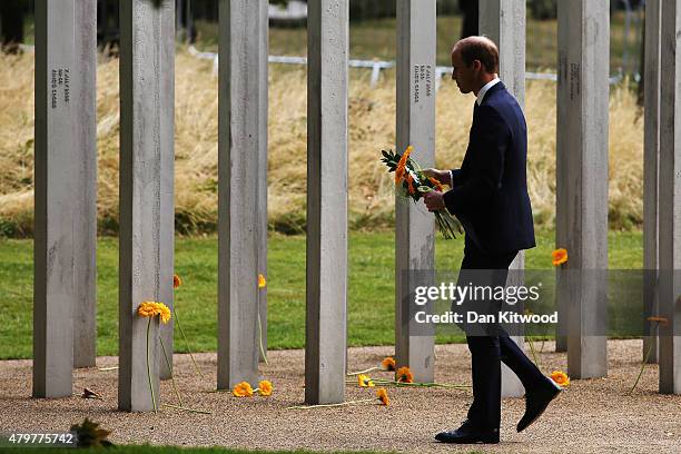 Prince William, Duke of Cambridge lays a flower at the 52 steel pillar memorial to the victims of the July 7, 2005 London bombings in Hyde Park on...