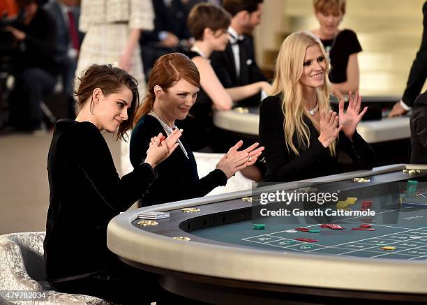 Kristen Stewart, Julianne Moore and Lara Stone attend the Chanel show as part of Paris Fashion Week Haute Couture Fall/Winter 2015/2016 at the Grand...