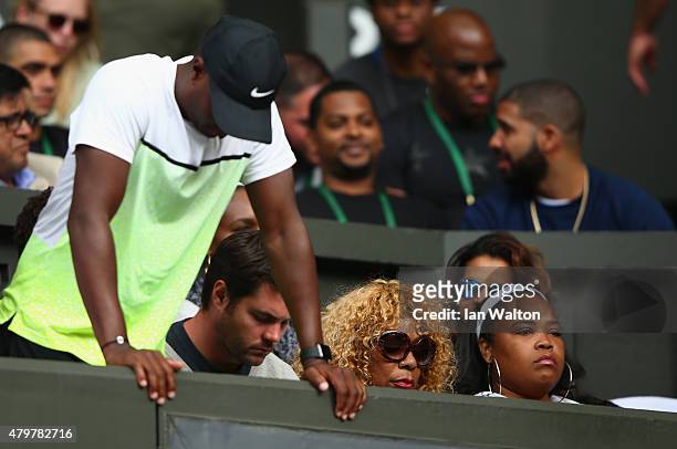 Half sister Isha Price and mother Oracene Price watch Serena Williams of the United States in her Ladies Singles Quarter Final match against Victoria...