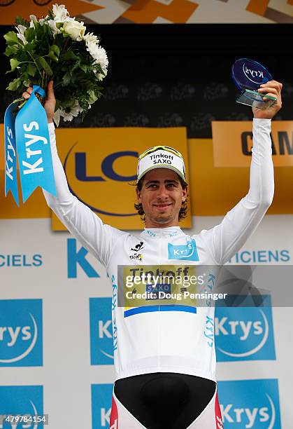 Peter Sagan of Slovakia and Tinkoff-Saxo celebrates as he is awarded the white jersey on the podium after stage four of the 2015 Tour de France, a...