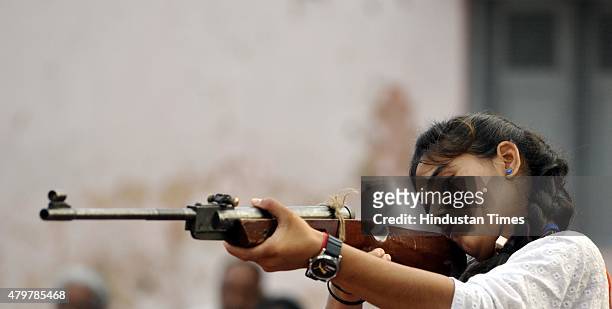 Member of Durga Vahini takes aim with her riffle during week-long self defense training camp on July 7, 2015 in Jammu, India. The Durga Vahini is the...