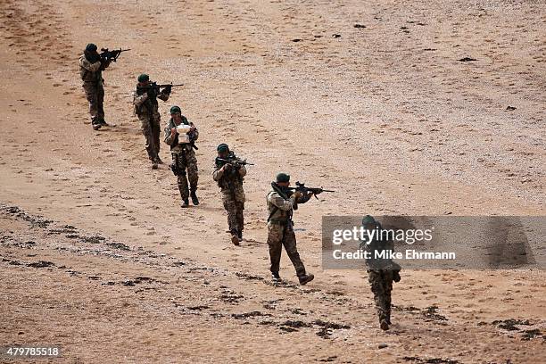 Troop of Royal Marines from the 43 Commando land on a beach via the Firth of Forth to deliver the Scottish Open trophy for 'safe keeping' prior to...
