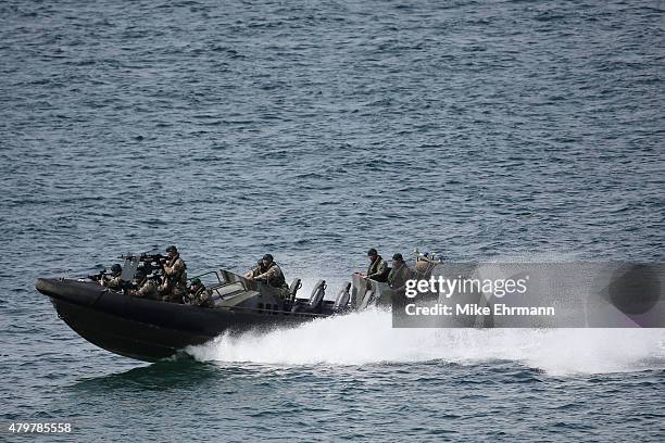 Troop of Royal Marines from the 43 Commando approach a beach via the Firth of Forth on an ORC to deliver the Scottish Open trophy for 'safe keeping'...