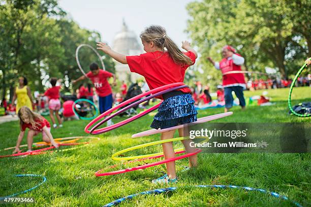 Olivia Yost of Pittsburgh, hula hoops during a "play-in" protest by kids and mothers in Upper Senate Park organized by Moms Clean Air Force, July 7,...