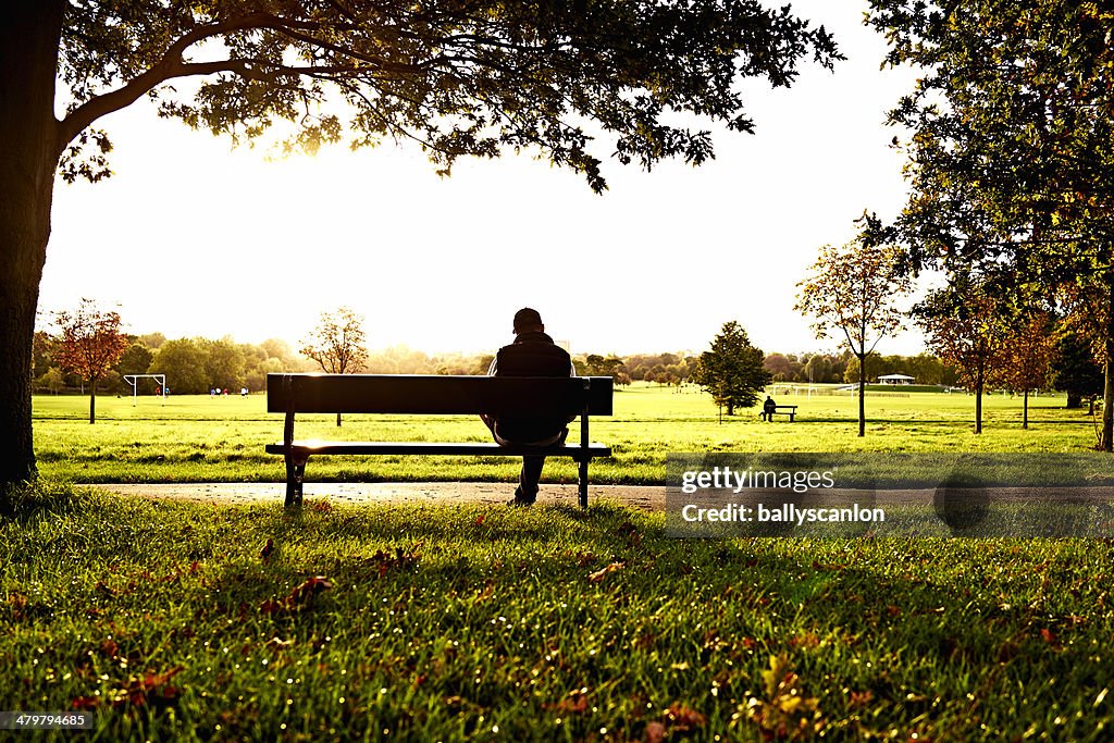 Man sitting on park bench