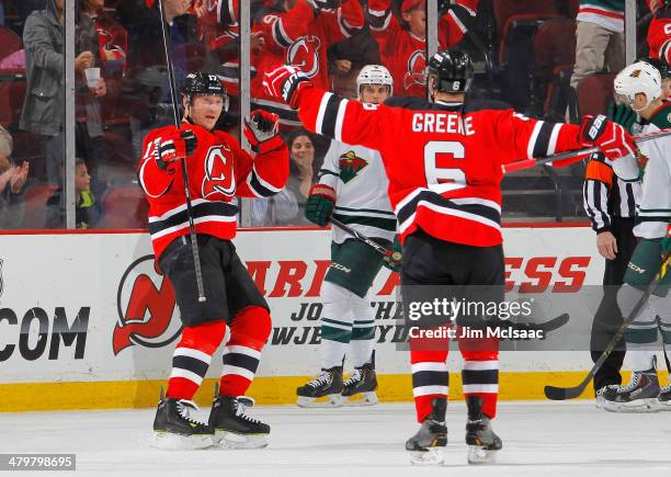 Michael Ryder of the New Jersey Devils celebrates his first period goal against the Minnesota Wild with teammate Andy Greene at the Prudential Center...