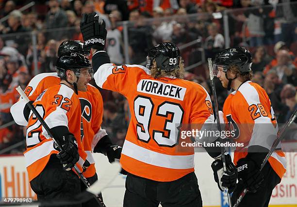 Mark Streit, Nicklas Grossmann, Jakub Voracek, and Claude Giroux of the Philadelphia Flyers celebrate Streit's first period goal against the Dallas...