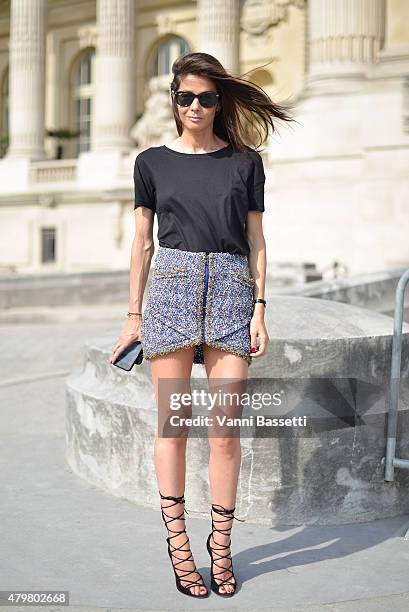 Barbara Martelo poses wearing a chanel skirt, Alexander Wang top and Azzedine Alaia shoes before the Chanel show at the Grand Palais on July 7, 2015...