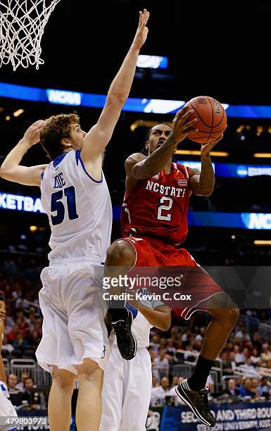 Anthony Barber of the North Carolina State Wolfpack makes a layup in the first half against Rob Loe of the Saint Louis Billikens during the second...