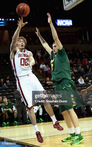 Ryan Spangler of the Oklahoma Sooners takes a shot over Marshall Bjorklund of the North Dakota State Bison during the second round of the 2014 NCAA...