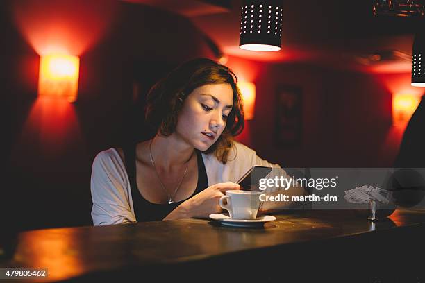 girl using smartphone in a cafe - bar girl stock pictures, royalty-free photos & images