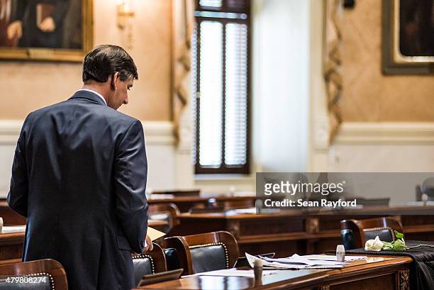 State Sen. Vincent Sheehen looks at notes near the desk of Sen. Clementa Pinckney in the Senate chambers July 7, 2015 in Columbia, South Carolina....
