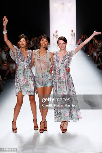 Models Vanessa Fuchs, Anuthida Ploypetch and Ajsa Selimovic walk the runway at the Riani show during the Mercedes-Benz Fashion Week Berlin...