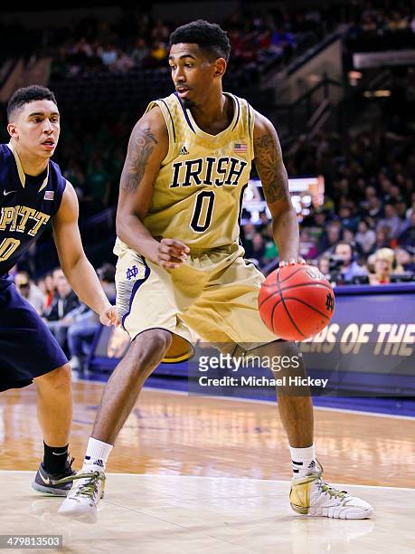 Eric Atkins of the Notre Dame Fighting Irish drives to the basket against James Robinson of the Pittsburgh Panthers at Purcel Pavilion on March 1,...