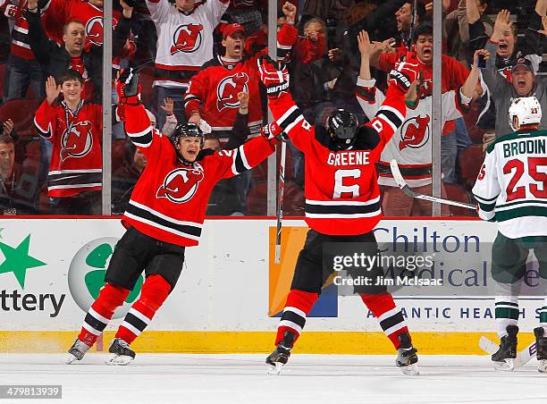 Andy Greene of the New Jersey Devils celebrates his overtime goal against the Minnesota Wild with teammate Patrik Elias at the Prudential Center on...