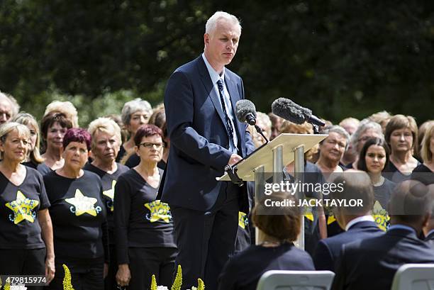 Paul Dadge, who was pictured helping a woman following the London bombing speaks during a service at the 7/7 memorial in London's Hyde Park on July 7...