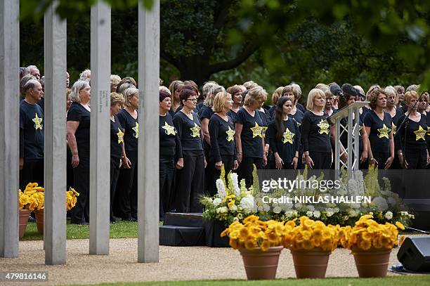 Members of the Rock Choir stand during a service at the 7/7 memorial in London's Hyde Park on July 7 in memory of the 52 people killed during the 7/7...