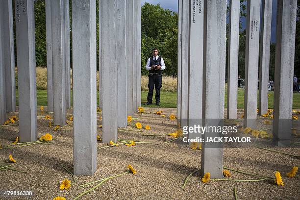 Police officer pays his respects after a service at the 7/7 memorial in London's Hyde Park on July 7 in memory of the 52 people killed during the 7/7...