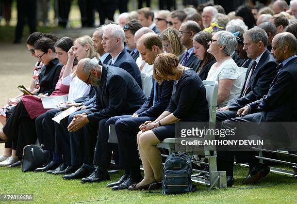 Britain's Prince William, Duke of Cambridge bows his head during a service at the 7/7 memorial in London's Hyde Park on July 7 in memory of the 52...