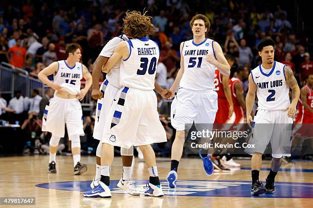 Jake Barnett of the Saint Louis Billikens celebrates with teammate Jordair Jett after defeating the North Carolina State Wolfpack in overtime during...