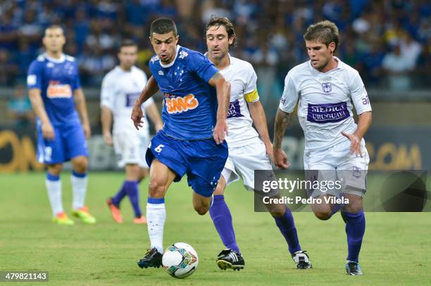 Fleurquin Andres and Gino Federico of Defensor and Egidio of Cruzeiro during the match between Cruzeiro v Defensor for the Copa Briedgestone...