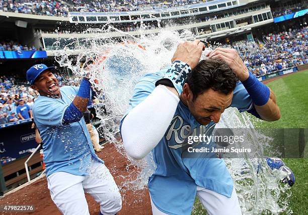 Paulo Orlando of the Kansas City Royals is doused with water by catcher Salvador Perez after hitting a walk-off grand slam in the bottom of the 9th...
