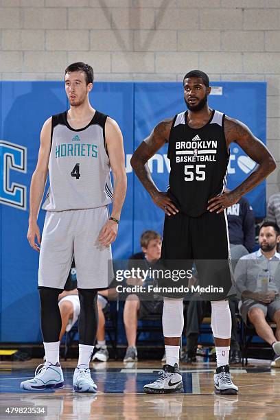 Frank Kaminsky of the Charlotte Hornets and Earl Clark of the Brooklyn Nets stand on the court during a game on July 7, 2015 at Amway Center in...