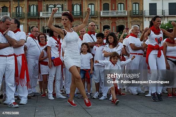 Revellers and children dance during the second day of the San Fermin Running of the Bulls festival on July 7, 2015 in Pamplona, Spain. The annual...