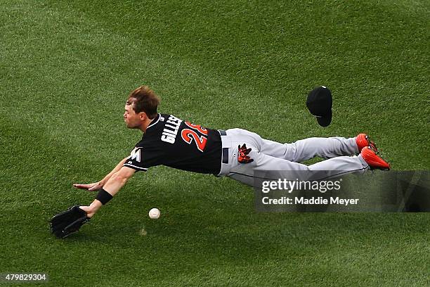 Cole Gillespie of the Miami Marlins dives missing a catch in the second inning against the Boston Red Sox at Fenway Park on July 7, 2015 in Boston,...