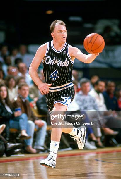 Scott Skiles of the Orlando Magic dribbles the ball up court against the Washington Bullets during an NBA basketball game circa 1990 at the Capital...