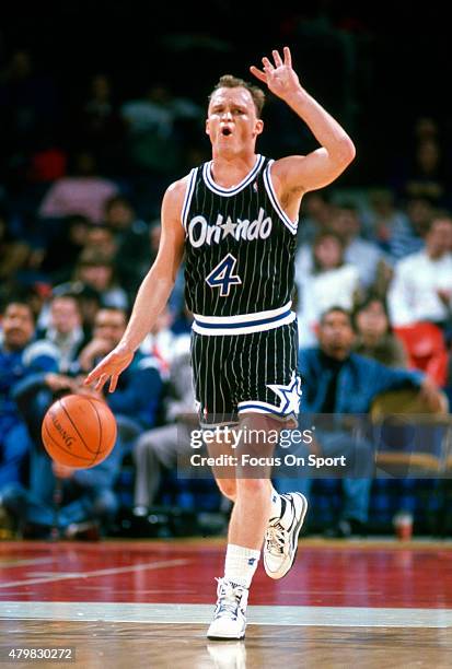 Scott Skiles of the Orlando Magic dribbles the ball up court against the Washington Bullets during an NBA basketball game circa 1990 at the Capital...