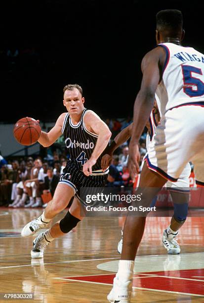 Scott Skiles of the Orlando Magic dribbles the ball against the Washington Bullets during an NBA basketball game circa 1991 at the Capital Centre in...