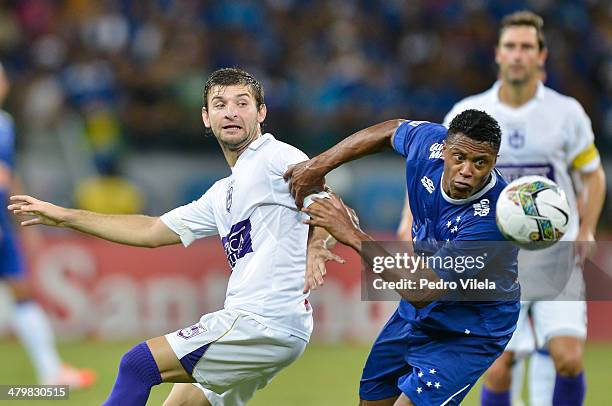 Julio Baptista of Cruzeiro and Gaston Silva of Defensor during the match between Cruzeiro v Defensor for the Copa Briedgestone Libertadores 2014 at...