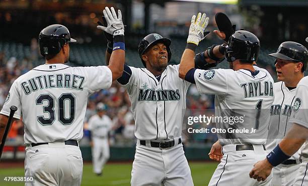 Austin Jackson of the Seattle Mariners is congratulated by teammates after hitting a grand slam in the third inning against the Detroit Tigers at...