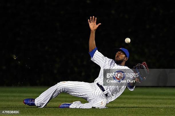 Dexter Fowler of the Chicago Cubs is unable to make a catch against the St. Louis Cardinals during the ninth inning during game two of a double...