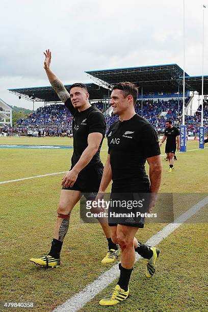 Sonny Bill Williams of the New Zealand All Blacks thanks the crowd with Daniel Carter of the New Zealand All Blacks after winning the International...