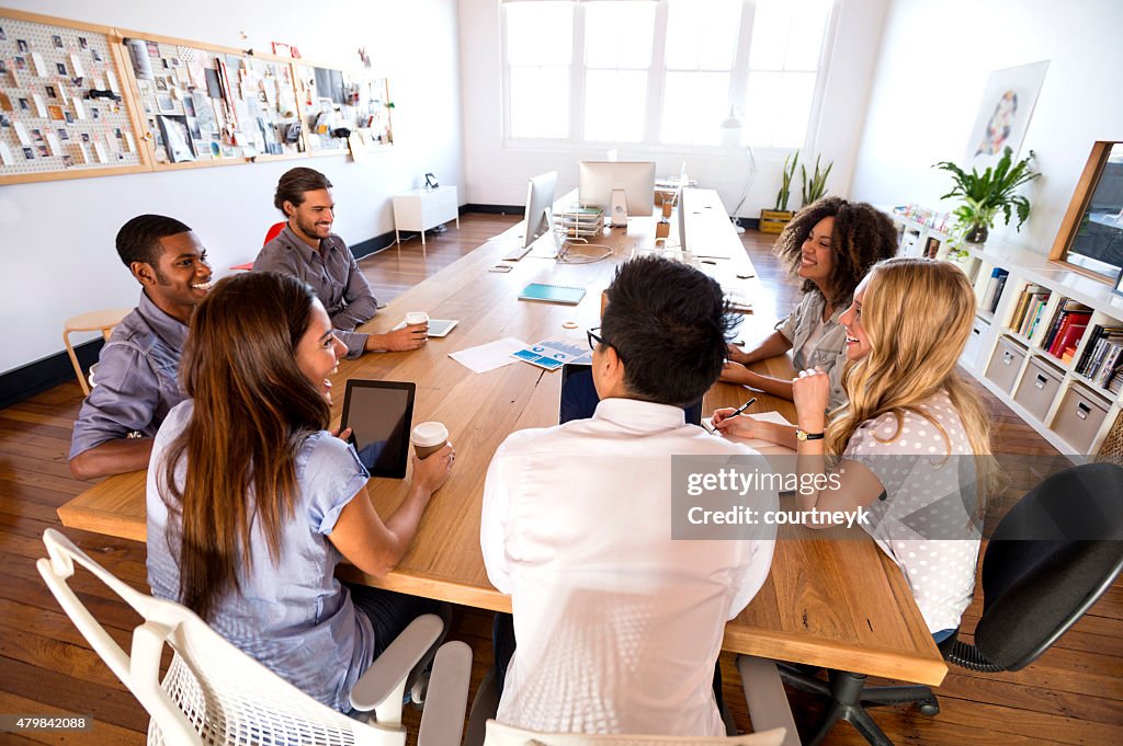 Group of young business people in a meeting.