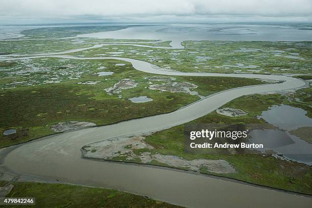 The marshy, tundra landscape surrounding Newtok is seen from a plane on July 6, 2015 outside Newtok, Alaska. Newtok, which has a population of...