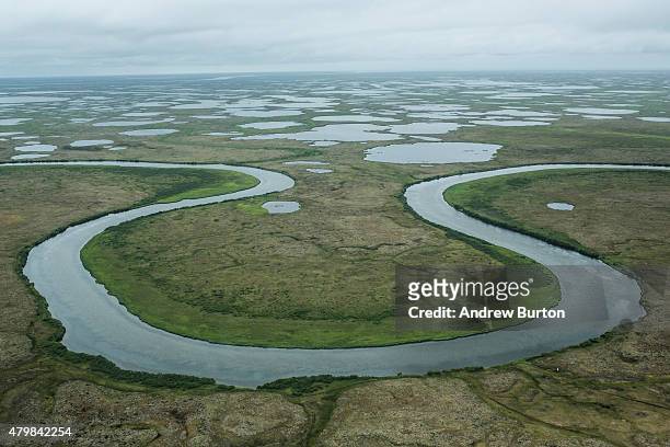 The marshy, tundra landscape surrounding Newtok is seen from a plane on July 6, 2015 outside Newtok, Alaska. Newtok, which has a population of...