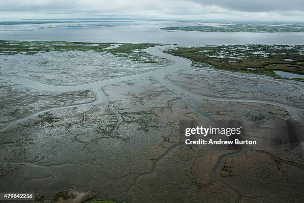 The marshy, tundra landscape surrounding Newtok is seen from a plane on July 6, 2015 outside Newtok, Alaska. Newtok, which has a population of...