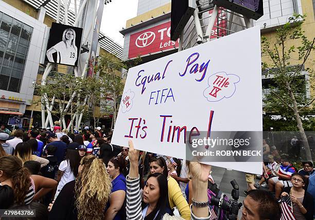 Soccer fan holds up a sign calling for equal pay for female athletes, at the US Women's World Cup football team's championship celebration rally, at...