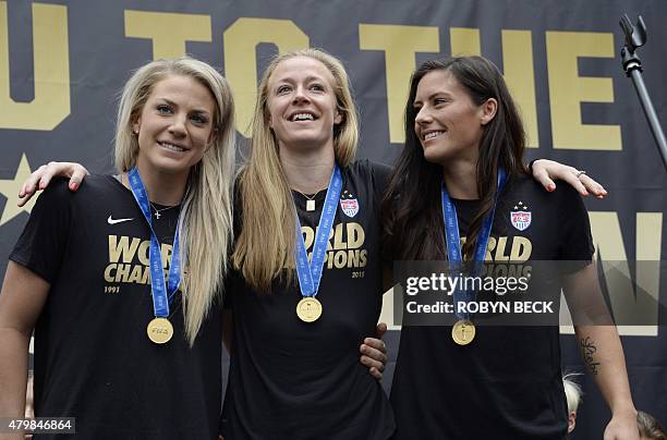 Defenders Julie Johnston , Becky Sauerbrunn , and Ali Krieger attend the US Women's World Cup football team's championship rally, at L.A. LIVE in...