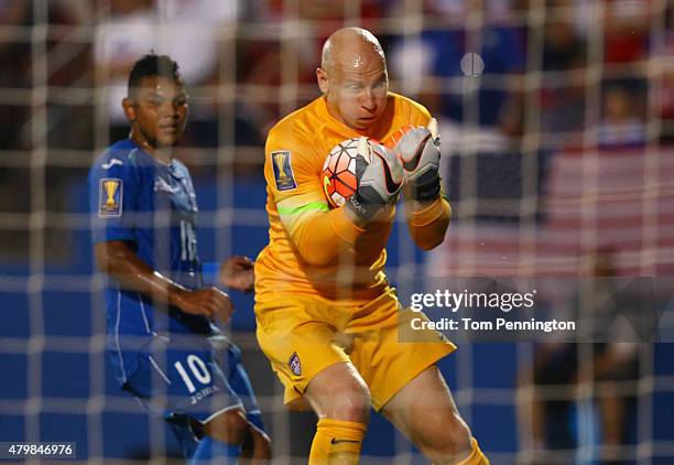 Brad Guzan of the USA blocks a shot against Mario Martinez of Honduras during the 2015 CONCACAF Gold Cup Group A match between USA and Honduras at...