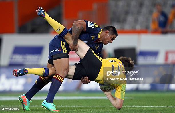 Malakai Fekitoa of the Highlanders hits Conrad Smith in a tackle during the round six Super Rugby match between the Highlanders and the Hurricanes at...