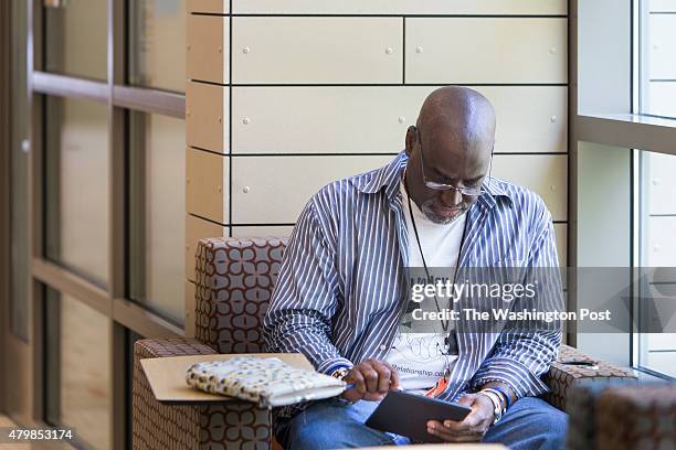 Mike Regan downloads articles onto his Nook e-reader at the newly renovated Woodrow Wilson Library in Falls Church, Virginia on May 8th. Regan lives...