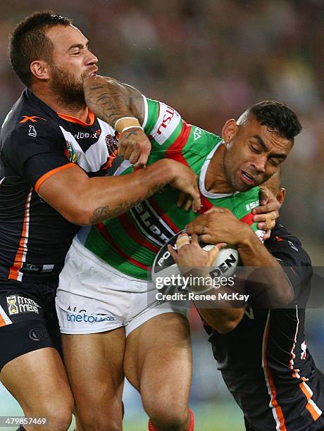 Nathan Merritt of Souths is tackled by Bodene Thompson during the round three NRL match between the Wests Tigers and the South Sydney Rabbitohs at...