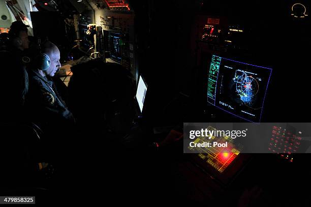 Flight Leiutenant Neville Dawson on board a Royal Australian Airforce AP-3C Orion from Pearce Airforce Base during a search mission for possible...