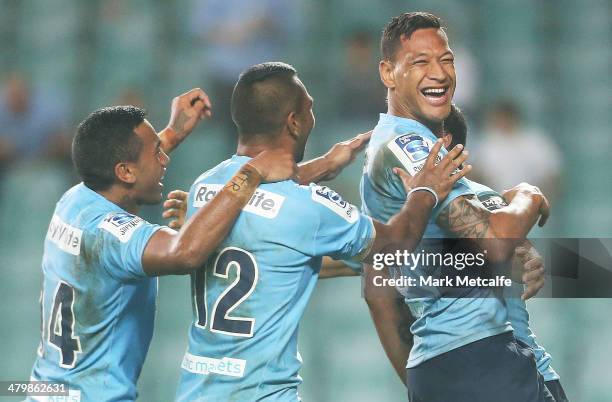Israel Folau of the Waratahs celebrates with team mates Kurtley Beale and Alofa Alofa after scoring a try during the round six Super Rugby match...